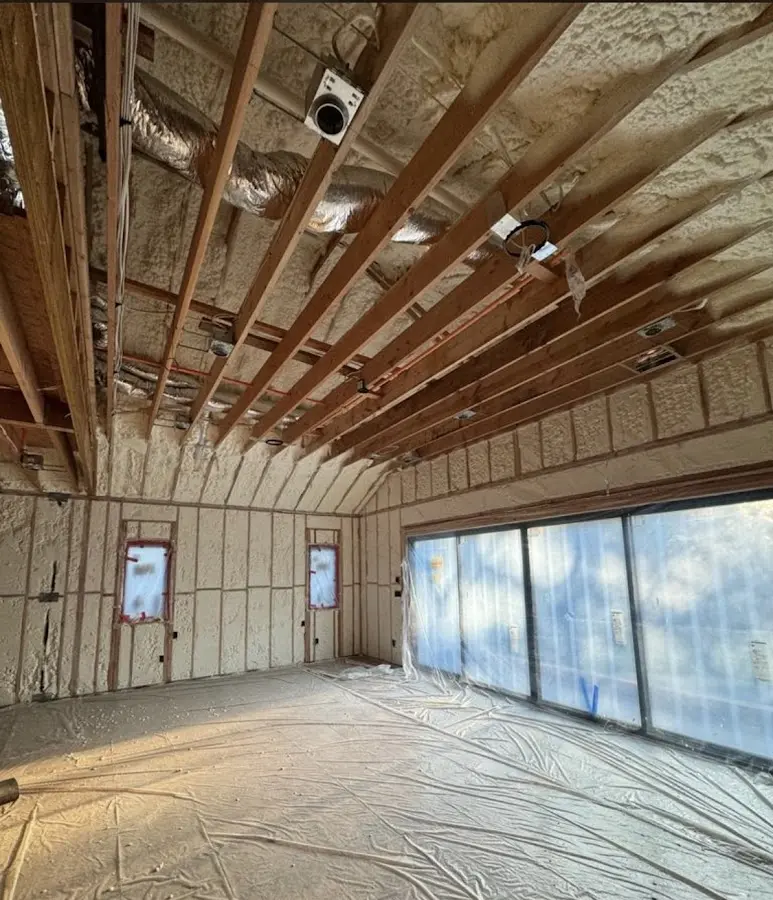 Interior walls and ceiling insulated with spray foam during new construction in Berlin